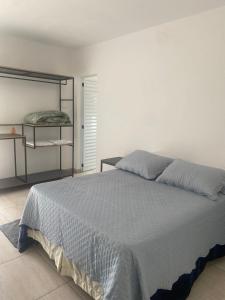 a bedroom with a bed and a book shelf at VILLAGE Host Hotel in Pedra Bela