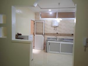 a kitchen with a sink and a refrigerator at Appartement à louer Tiznit 2 in Tiznit +9 photos