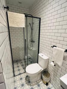 a bathroom with a toilet and a glass shower at Bairro Alto in Lisbon