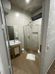 a bathroom with a shower and a sink at Teia-AJ in Praia