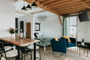 a dining room and living room with a table and chairs at Hegyi Pihenő in Zebegény