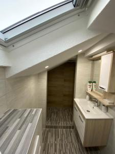 uma casa de banho com um lavatório e uma clarabóia em Kula Apartman 2 em Brcko