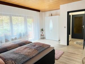 a bedroom with a bed and a large window at 3 Zimmer Ferienwohnung Denis in Oberwesel