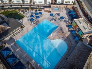 an overhead view of a swimming pool with blue umbrellas at Villa 27 - 4 Bedroom Townhome! Pool and Hot Tub! in St. George