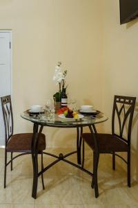 a table with two chairs and a plate of fruit on it at Cozi Cottage, A Tranquil Beauty in The Rock