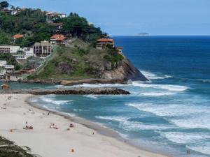 una playa con gente en la arena y el océano en Apart Hotel Barra Leme com Vista Mar Maravillhosa B1-002o, en Río de Janeiro