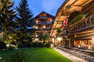 an exterior view of a house with a yard at Fer à Cheval in Megève