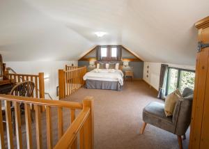 a large bedroom with a bed and a staircase at The Old Stables at Humblebee Hall in Worcester