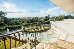 a balcony with a table and chairs and a view at Musses Studios in Minia