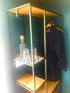 a glass cabinet with glasses and a shirt in it at The Welcome Snug in Kinsale