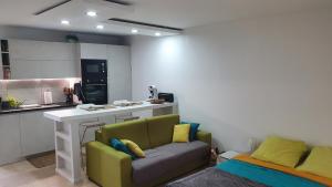 a living room with a couch and a kitchen at U Are We R St Martin Studio Cosy Marigot, Wi-Fi ,Piscine in Marigot +24 photos