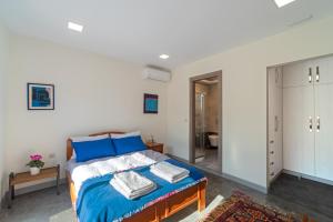 a bedroom with a bed and a bathroom at Seaside Private Beach Paradise in Kos Town