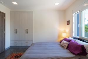 a bedroom with a large bed and a window at Seaside Private Beach Paradise in Kos