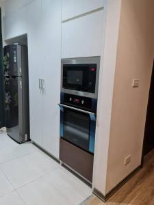 a kitchen with a microwave and an oven at Căn hộ cao cấp tầng cao đối diện Aeon Mall 2PN/2PT in Hanoi