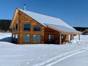 a wooden cabin in the snow with snow covered ground at Newly Built, Fire Pit, Kitchen in Rea