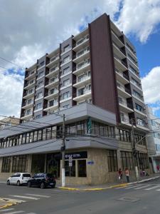 a large building on the corner of a street at Map Hotel in Lages