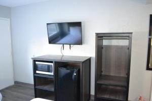 a flat screen tv sitting on top of a cabinet at Home 1 Great Stay in Jacksonville