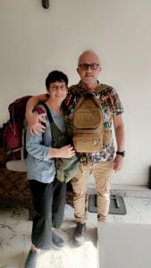 two people standing next to each other with a backpack at hotel khubsaras palace by chhabra's in Agra