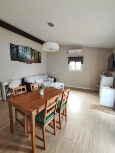 a living room with a wooden table and chairs at Can Costals Terraza in Pals