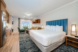 a hotel room with a large bed and a living room at Hallmark Resort in Cannon Beach in Cannon Beach