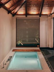 a swimming pool in the middle of a room with a window at Juwoldam in Jeju