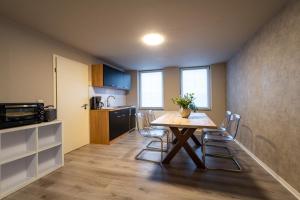 a kitchen and dining room with a table and chairs at Bördeapartment am Heiderand 