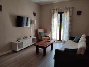 a living room with a couch and a table at Can Costals Naturaleza in Pals