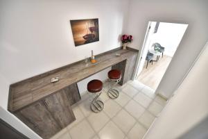 a kitchen with a counter with two stools in a room at Luxury Studio / M Romancierilor in Bucharest +18 photos