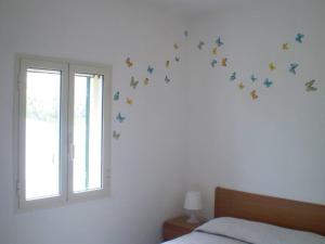 a bedroom with a bed with butterflies on the wall at La Marina Bay in Vieste