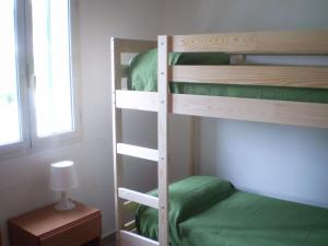 a bedroom with a bunk bed with green sheets at La Marina Bay in Vieste