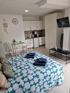 a bedroom with a bed with two towels on it at APARTAMENTOS ELEMAR free luggage storage in Málaga