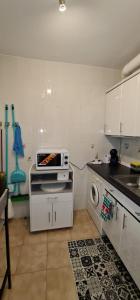 a small kitchen with a microwave on a counter at Casa La Torre in Cepeda