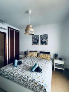 a bedroom with a bed with blue pillows on it at Lovely Casa Sueños, heated pool x snooker table in Playa Blanca +55 photos