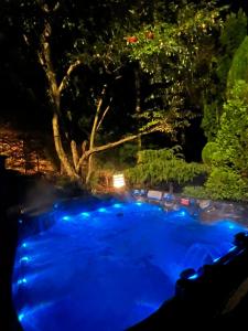 a swimming pool with blue lights at night at Ailim House Serviced Cottage Escape, around the corner from the Old Course in St Andrews