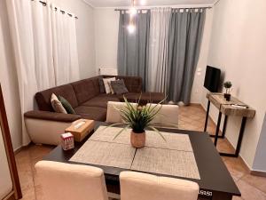 a living room with a couch and a table at CW Flat in Alexandroupoli