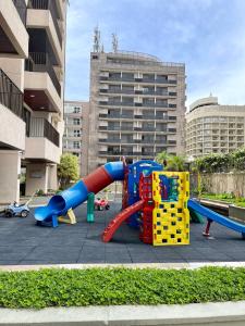 a playground with colorful play equipment in a city at Arpoador Vista Mar in Rio de Janeiro