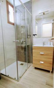 a bathroom with a glass shower and a sink at Sunshine 435 in Playa del Ingles