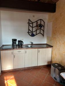 a kitchen with a sink and a shelf on the wall at Raminorca in Ramin