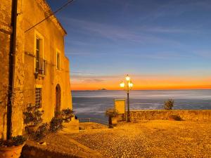 a street light next to a building with a view of the ocean at Residenza Matilde in Fiumefreddo Bruzio