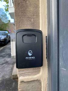 a black button on the side of a building at Studio 2 in Matlock