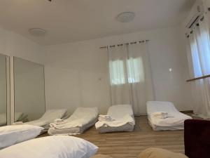 a room with four beds and a mirror at Hollyday & vacation in Beit Hillel
