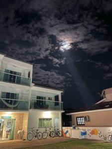 a house with bikes parked outside of it at night at Ipê Palmas Hostel in Governador Celso Ramos