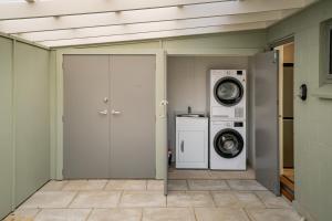 a laundry room with a washing machine and a washer at Lakeview in Lake Hawea