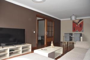 sala de estar con sofá y TV en Apartamento complejo residencial en Las Palmas de Gran Canaria