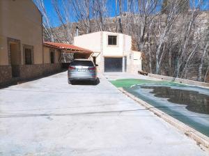 a car parked in the driveway of a house at casas rurales ivan el penas 3 in Letur