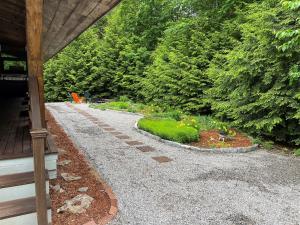 a garden with a gravel walkway next to a house at GOOD TIMES CHALET LIMIT 19 chalet in Bridgton
