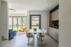 a kitchen and dining room with a table and chairs at Casa degli Ulivi - Ossuccio, Tremezzina by LoveComo in Isola Comacina