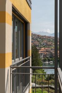 a balcony of a building with a view of the water at Casa degli Ulivi - Ossuccio - Tremezzina in Isola Comacina
