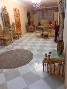 a living room with chairs and a checkerboard floor at شقه مفروش in Cairo