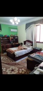 a bedroom with two beds and a dresser at شقه مفروش in Cairo
